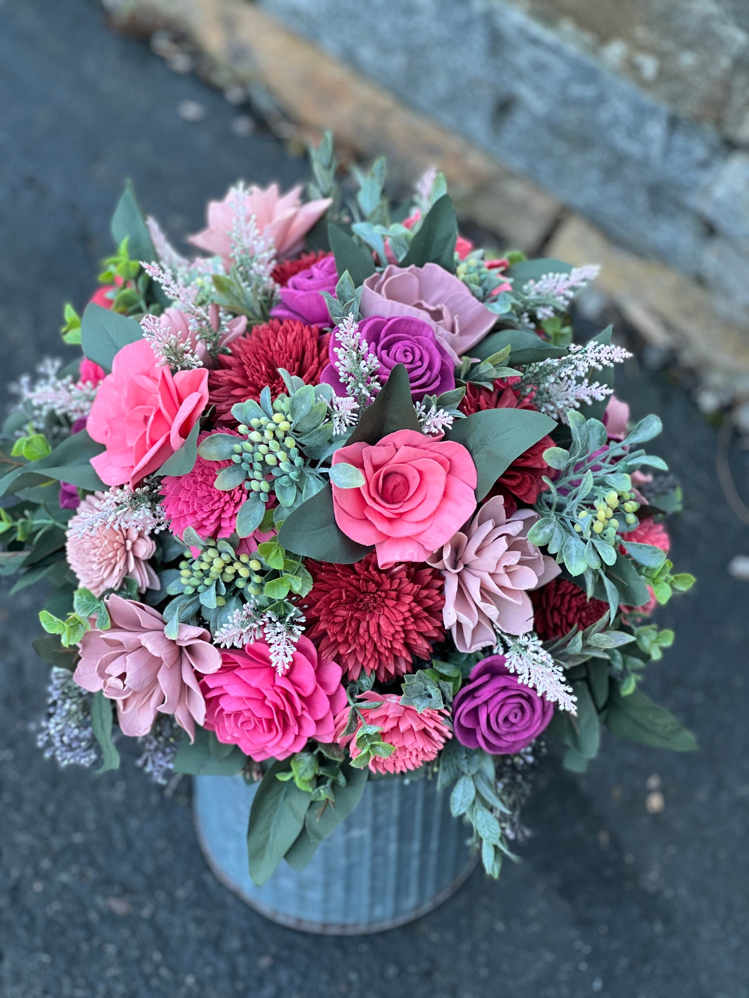 blush, pink, red, and mauve wood flower bouquet